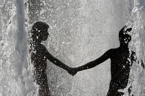 silhouettes dancing in the water