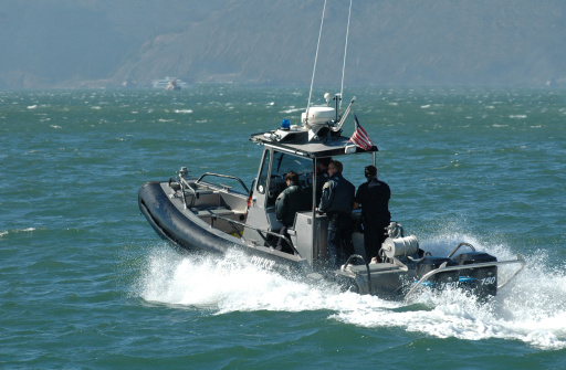 A shot of a US Coast guard speedboat and police officers in San Francisco Bay.