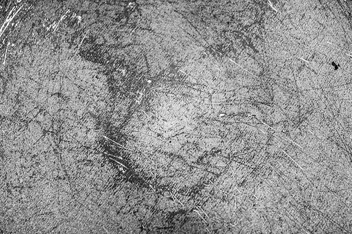 The Grunge black texture. The texture of the scratches on the metal. Texture scratches background monochrome. Rough textured hard background. The surface is damaged.