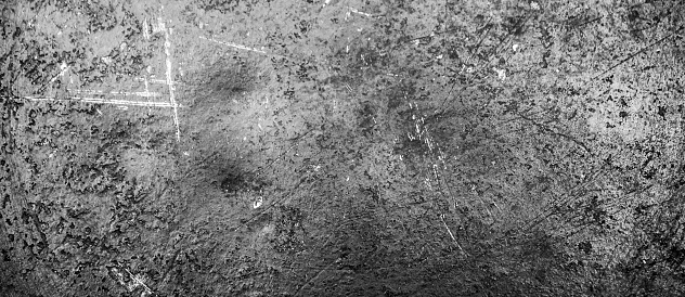 The Grunge black texture. The texture of the scratches on the metal. Texture scratches background monochrome. Rough textured hard background. The surface is damaged.