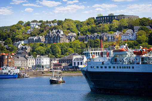 Holidays in Scotland - scenic view of Oban on the west coast of Scotland with harbour and  the Mccaig's Tower on the hill