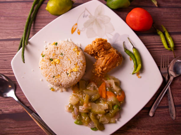 istock fried rice with fried chicken in a dish top view on wooden background 1402718134