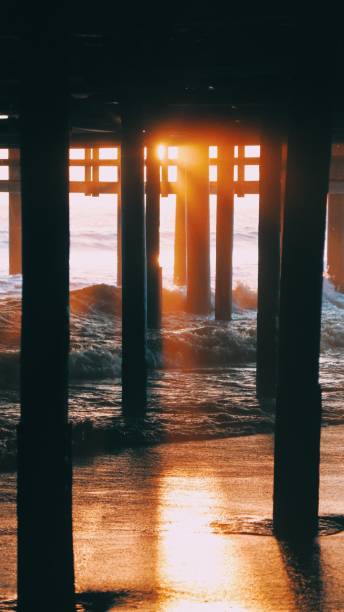 catching sunset at santa monica beach - santa monica beach beach california wave imagens e fotografias de stock
