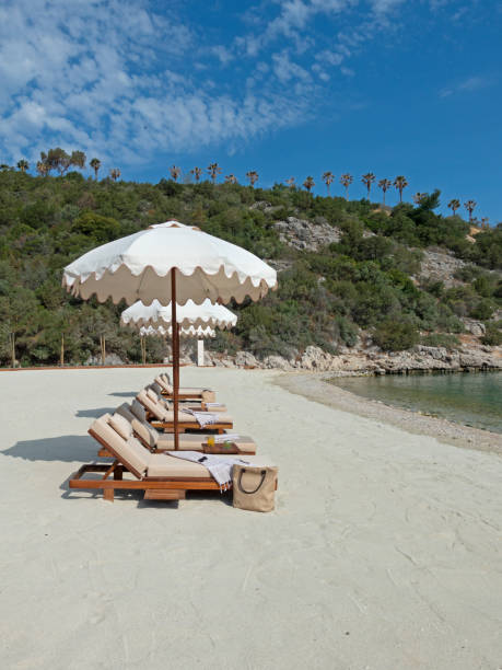 istock Beach chairs with umbrellas and beautiful sand beach 1402718233