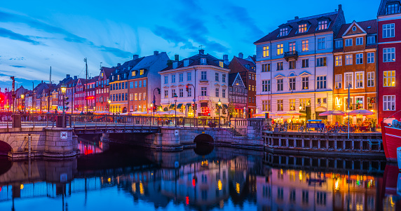 Copenhagen bars restaurants Nyhavn warmly illuminated at dusk panorama Denmark
