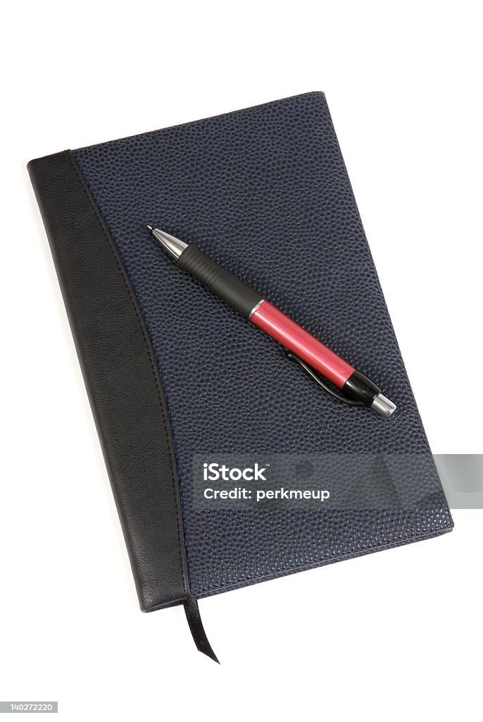 Diary and Pen 3 A blue leather bound diary on a white background with a pen Blue Stock Photo