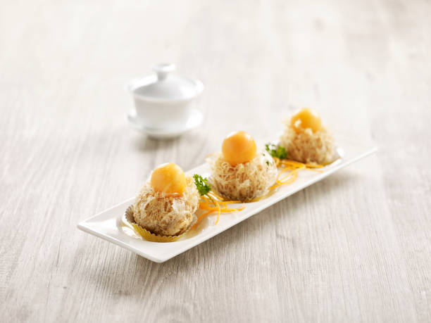 istock Deep-fried Yam Puff topped with Rock Melon served in a tray isolated on mat side view on grey background thailand fast food 1402723200