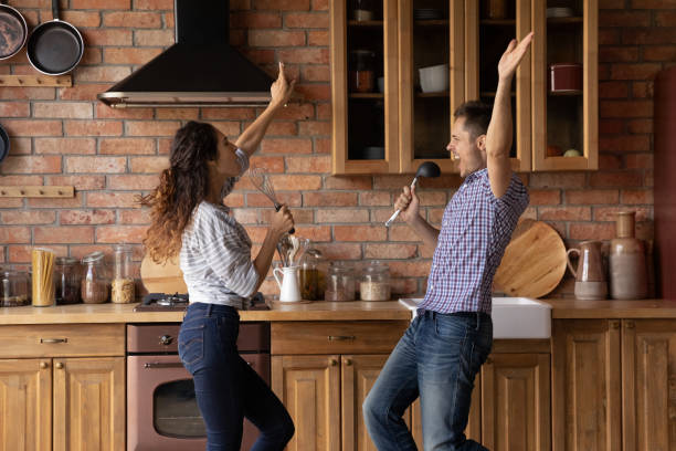 istock Overjoyed young sincere family couple having fun in kitchen. 1402723352