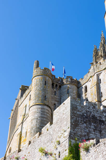 View from below on the Abbey of Mon Saint-Michel and its bell tower topped by the Archangel Saint-Michel stock photo