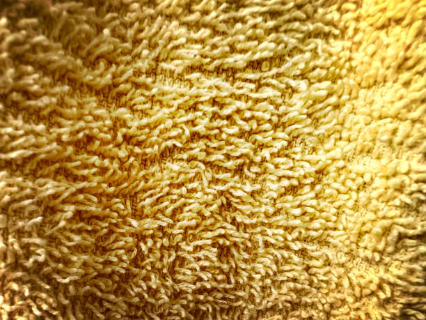 A macro image of a yellow towel.