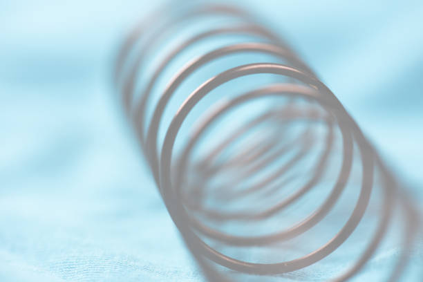 istock Details of a metal spring on pink cloth.. 1402726209