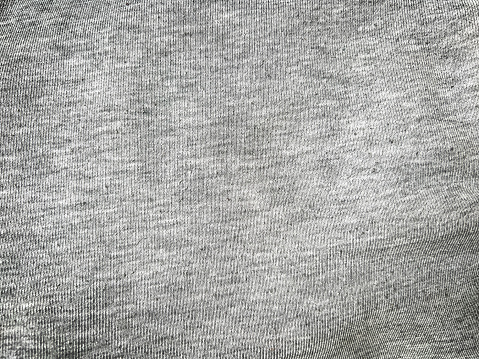 A fine light grey fabric as a texture or background.