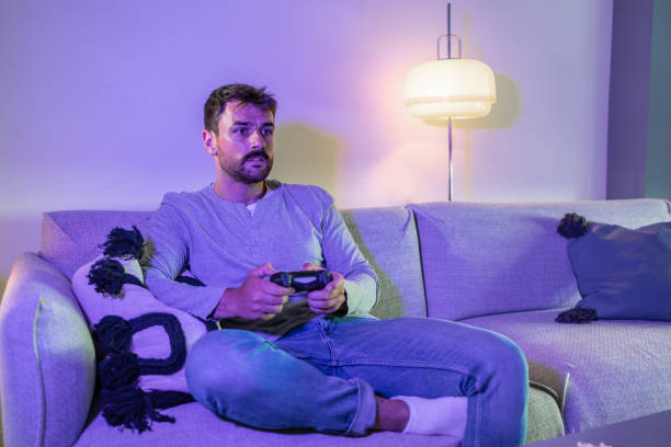 istock Cozy night at home and playing video games online 1402728897