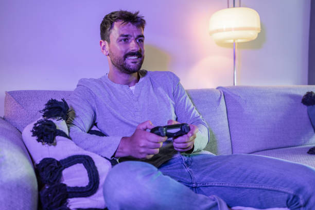 istock Cozy night at home and playing video games online 1402728924