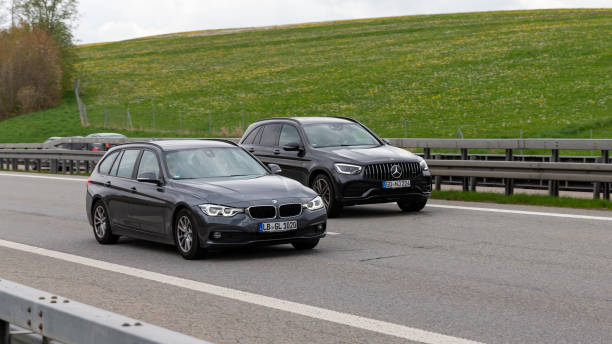 Mercedes Benz GLC overtaking a BMW 3-series on the A7 Autobahn stock photo