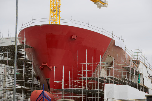 Shipbuilding and crane during ferry construction surrounded by scaffold UK