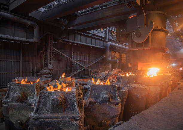 istock Steel pouring from casting ladle into metal molds. 1402732606