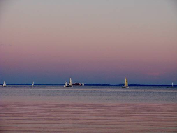 istock Sunset on the water with sailboats 1402732682