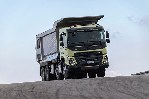 Goteborg, Sweden - 9th June, 2022: Volvo FMX 540 8x4 dump truck driving on a road. This truck is one of the most popular heavy truck in European transport companies.