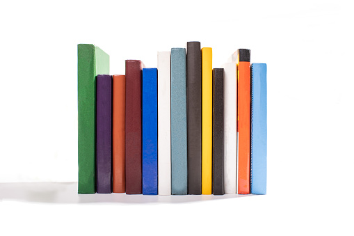 different color book spines isolated on white background