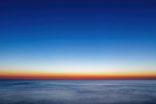 istock Moody sunrise over calm sea, abstract landscape 1402740343