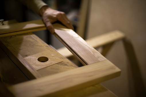 Carpenter makes wood. Board processing. Details of carpentry workshop.