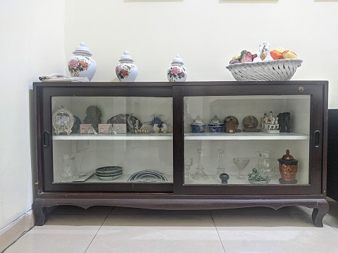 a small table that contains various items such as glasses, plates, jars