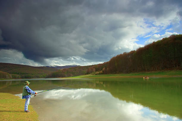 istock Fisherman catching fish on a lake 140274094