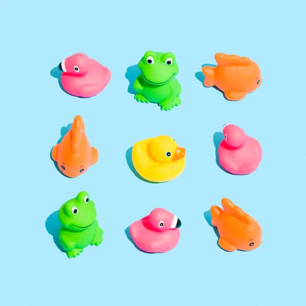 Photo of Creative pattern made of colorful rubber bath toys for babies. Water game concept.