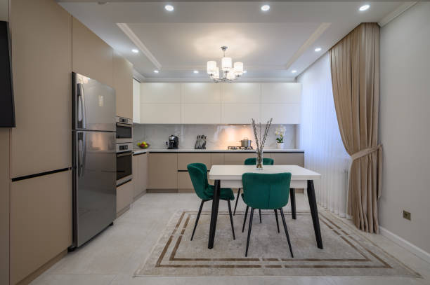 istock Modern white and beige large luxurious kitchen and dining table in studio apartment 1402742259