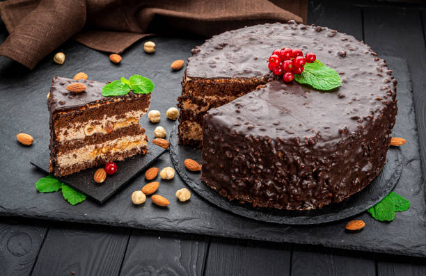 istock Delicious caramel chocolate tart, topped with nuts and hazelnuts, almonds 1402742991
