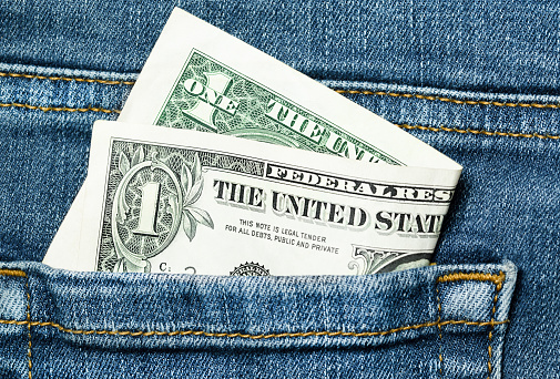 one dollar banknote in jeans pocket