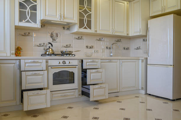 istock Classic white and beige kitchen furniture in studio apartment 1402743302
