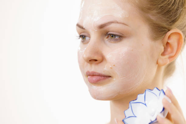 Young woman with cream cosmetic, mask moisture on her face. Beauty treatment. Skincare. Text area