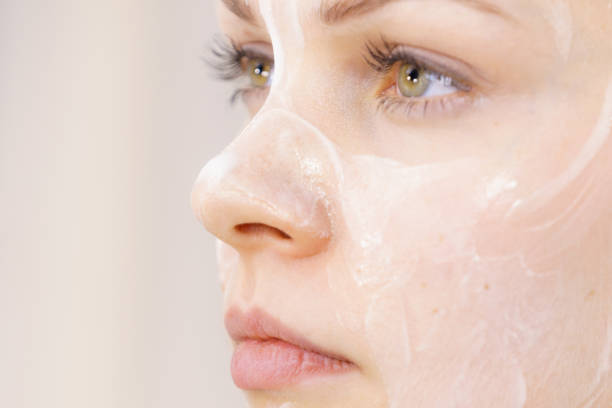 istock Girl with cream moisture cosmetic on face 1402745177