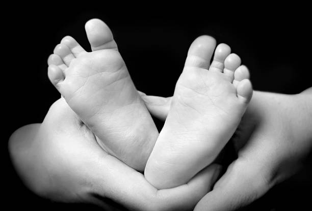 istock Mother's hands holdning hers son's feet 140274830