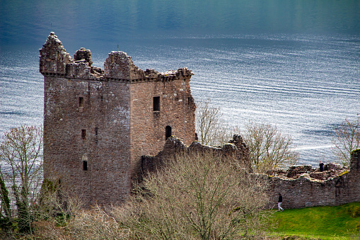 Drumnadroichit, Scotland, United Kingdom - May 1, 2022: Landscape view of Urquhart Castle ruins (Caisteal na Sròine) along Loch Ness in the Highlands of Scotland. The castle dates back to the 13th Century, and was an important location in the Scottish independence wars of the 13th and 14th Centuries.