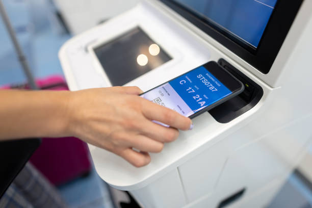 istock Woman using smart phone at auto checkin counter 1402749082