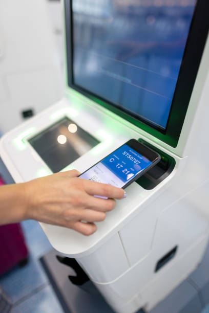 istock Woman using smart phone at auto checkin counter 1402749106