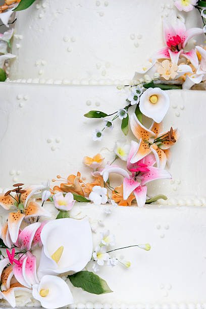 Wedding cake detail A wonderful wedding cake detail. The flowers look real, but are really edible sugar flowers! wedding cake close up macro stock pictures, royalty-free photos & images