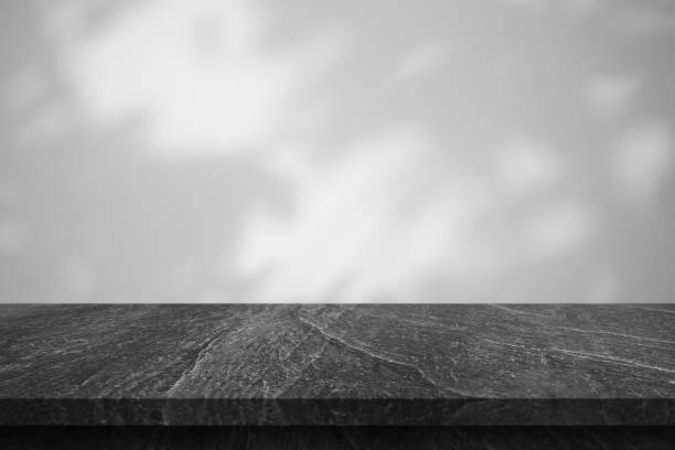 istock Marble table with tree shadow drop on white wall background for mockup product display 1402754069