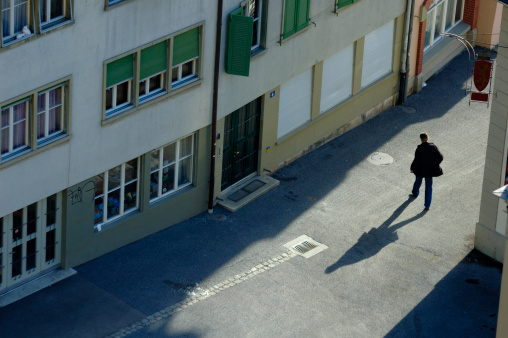 A man walks through the streets of the Swiss federal capital, Bern, in the early morning. 