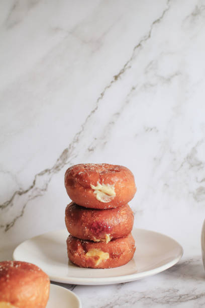 istock Doughnuts with Creamy Lemon Filling Dusted on white background. copy space for your text. Snack food and dessert. 1402756526