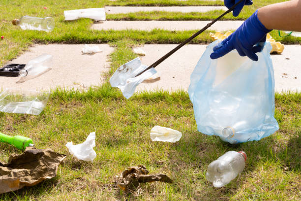 volunteer picking up rubbish in a park at horizontal composition