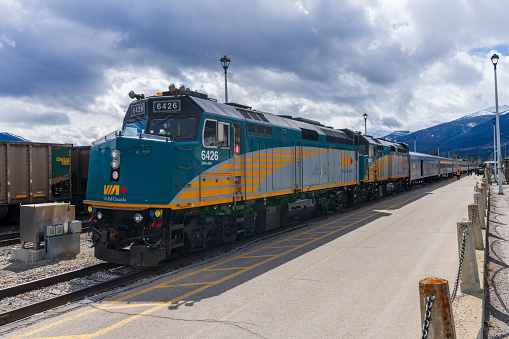 Jasper, Alberta, Canada - May 1 2021 : Via Rail F40PH-2D public passenger train stop at the Jasper station platform.