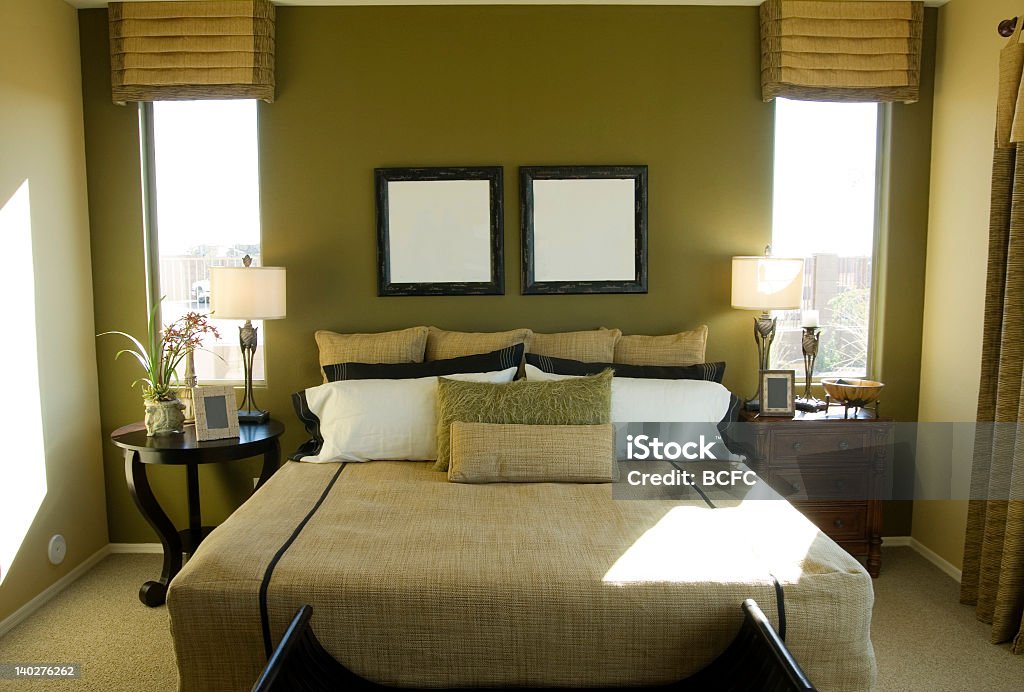 A modern bedroom in greens and tan colors Modern Bedroom Design, part of a series of interior design images. Bed - Furniture Stock Photo
