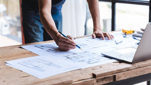 istock Male architect or engineer working at home drawing the construction project. 1402763273
