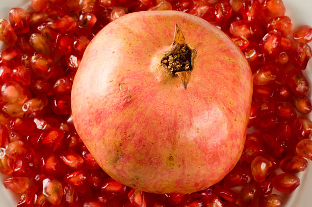 Pomegranate on grains stock photo