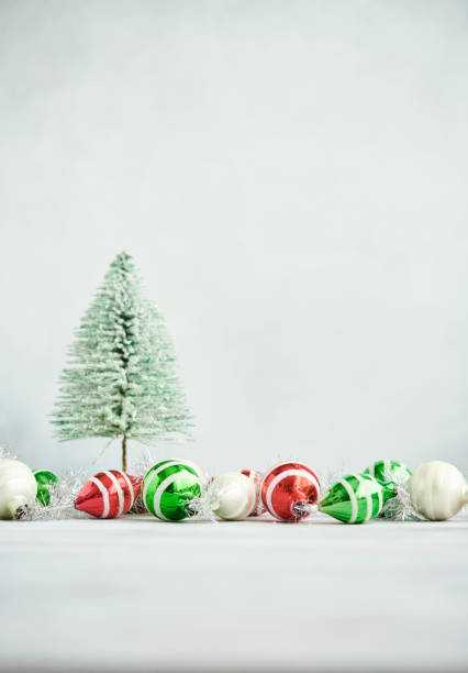 istock Christmas background with green tinsel tree and glittery Christmas decorations. Space for copy 1402766205