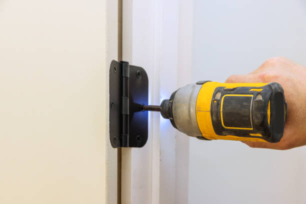 istock Installing the door hinge on the door frame using a screwdriver a home reconstruction 1402767269